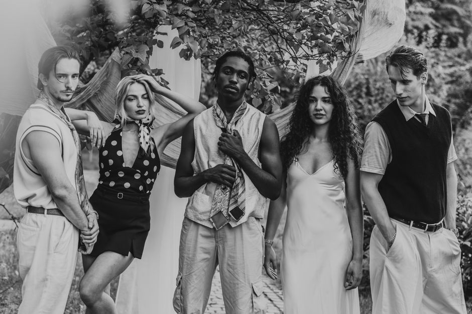 Stylish group portrait with vintage fashion outdoors, black and white.