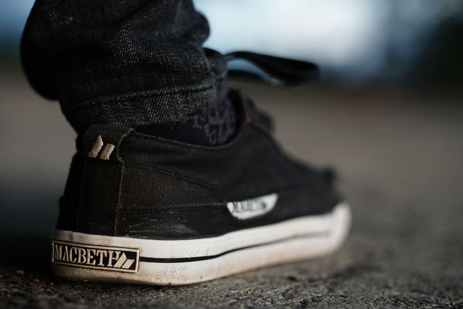 Close-up shot of a black sneaker on a pavement in Davao City, Philippines.