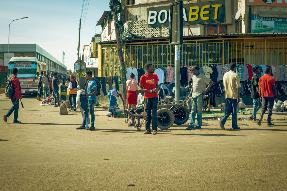 Dynamic street scene capturing a lively city market with people engaging in daily activities.