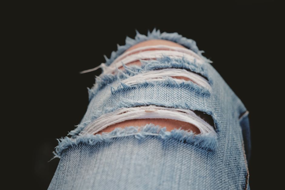 Detailed shot of torn denim jeans showcasing modern fashion and style.